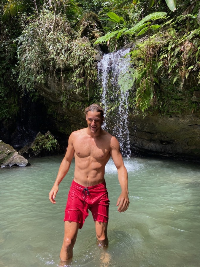 Mark Poli, founder of Regenerative Movement, at a waterfall in Puerto Rico