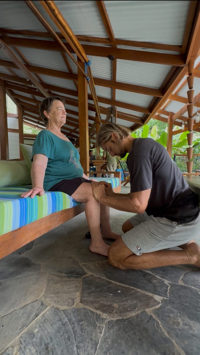 Mark Poli doing hands-on fascial release work with a client outdoors