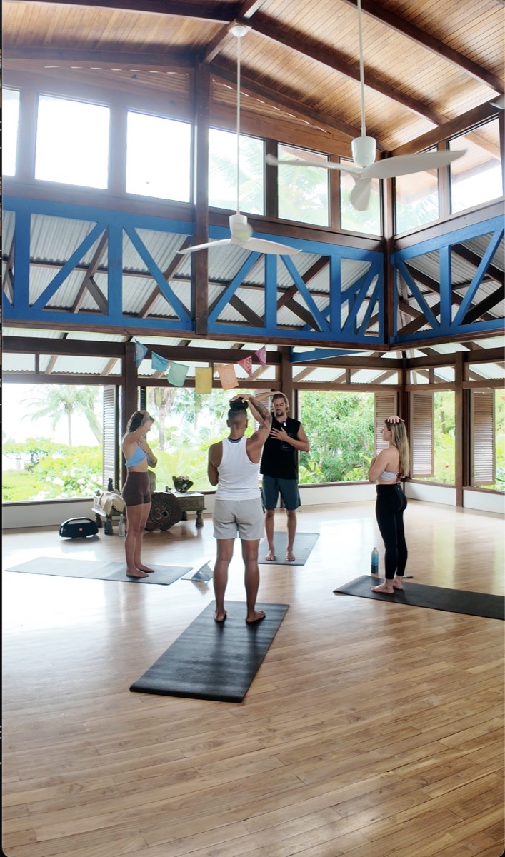 Mark Poli coaching a group session in a tropical open-air studio